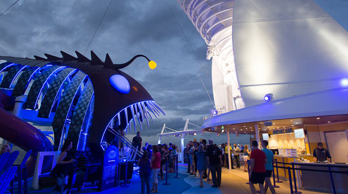 Guests waiting at the giant piranha-shaped entrance of the Ultimate Abyss
