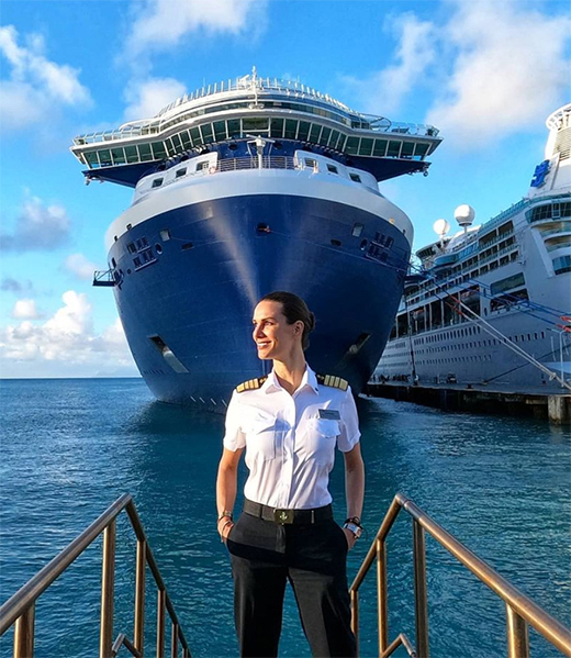 Kate McCue standing in front of her ship