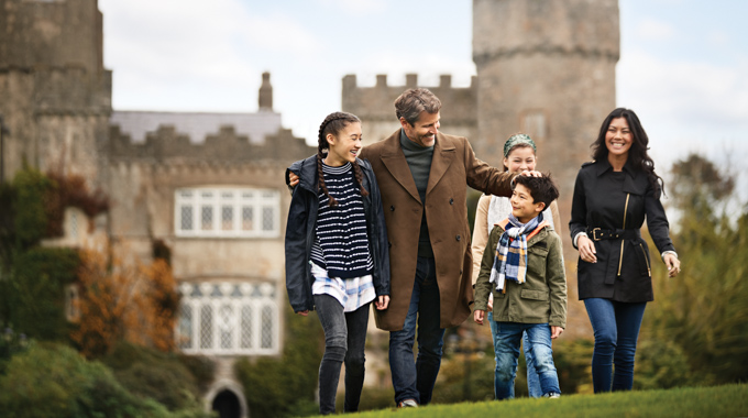 Family walking the grounds of a historic building