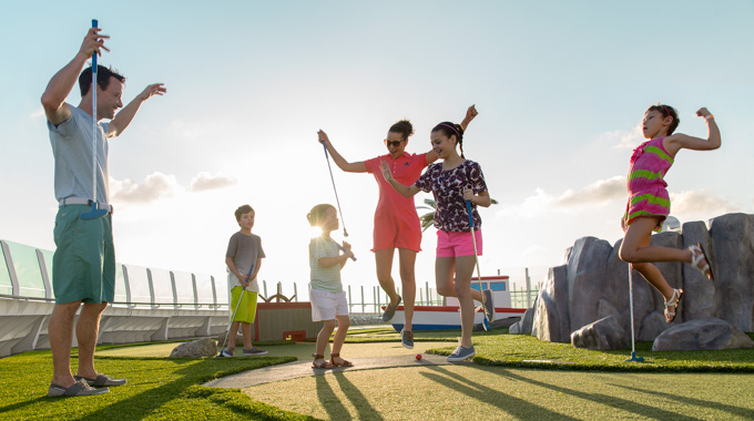 Family enjoying mini golf