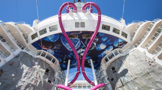 Looking upward at dual water slides on the Symphony of the Seas 