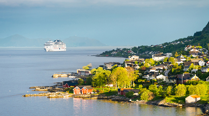 Cruise ship sitting off the shore of Alesund, Norway