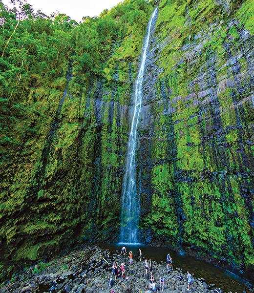 People enjoying Wailua Falls on the Road to Hana, Maui. | Photo by Don Landwehrle/stock.adobe.com