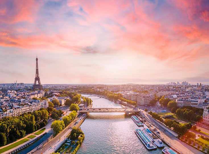 The Eiffel Tower and the Seine at sunset.