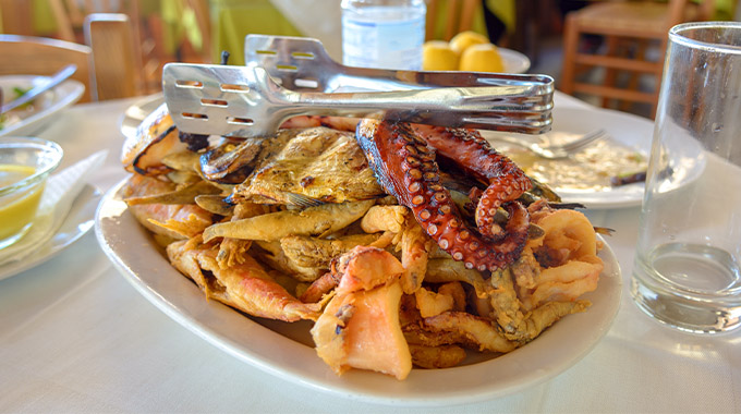 Seafood, grilled octopus, fish and prawns served in a traditional Greek tavern. Crete island. Greece.