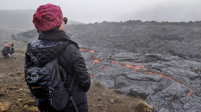 The author looks out at an active lava field near Reykjavík. | Photo courtesy of Jessica Fender