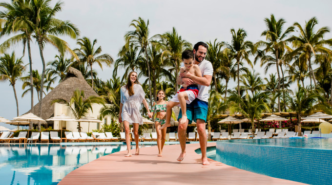 A family enjoys the pool at Grand Velas Riviera Nayarit. 