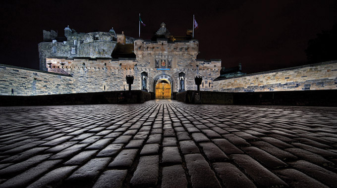 A night shot of Edinburgh Castle taken from a low angle on a wed night.