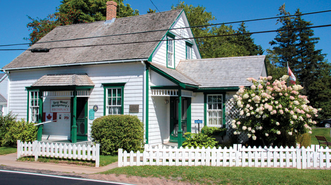 Exterior of a home, with a sign marking "Lucy Maud Montgomery's birthplace"