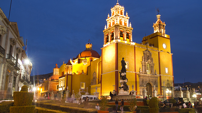 The Guanajuato Basilica's yellow facade lights up the night. | Dan Talson / Adobe Stock Photo