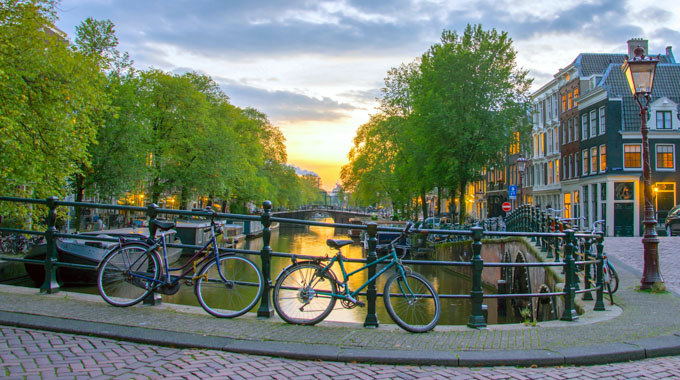 Bicycles parked beside the water in Amsterdam.