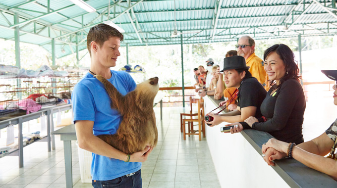 Visitors learn about sloths at The Sloth Sanctuary