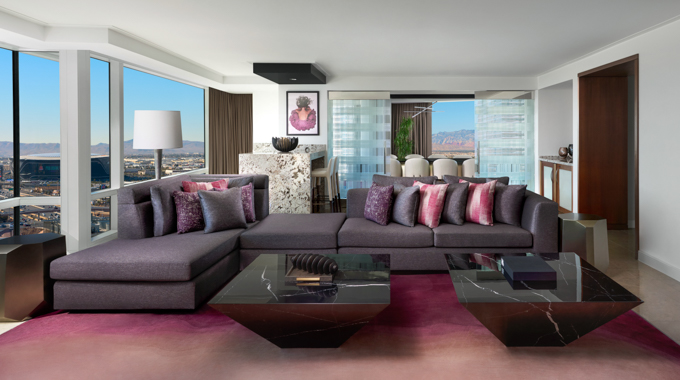 Couch lined with decorative pillows in a suite living area