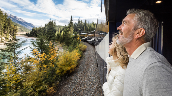 Couple looking at passing scenery from a train
