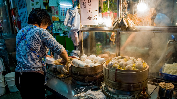 Vendor preparing dumplings at a food stall