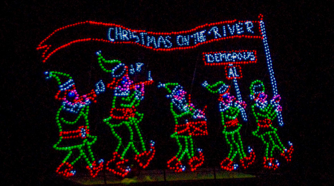 A "Christmas on the River" light sign
