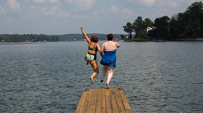 Meg and Amy jump off a dock at Lake Martin, recognized as one of the cleanest lakes in Alabama.