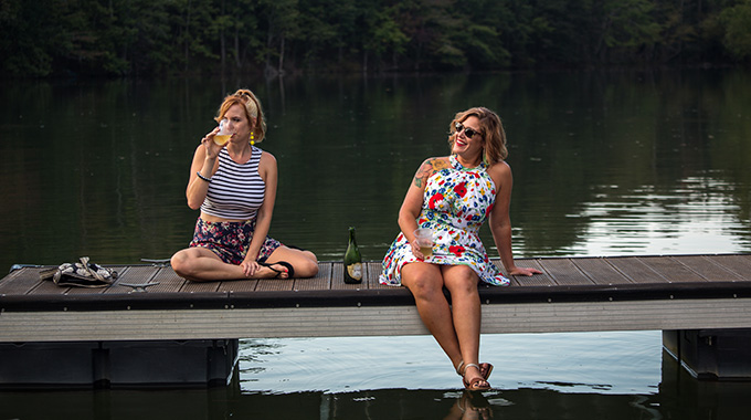 The author, left, and her friend Amy unwind dockside after a day on the lake.