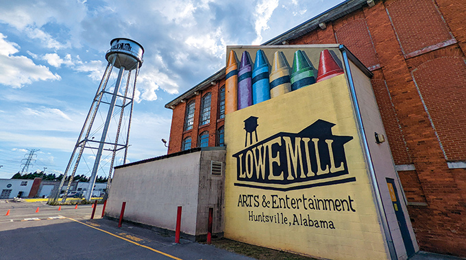 A mural of a box of crayons on the Lowe Mill Arts & Entertainment Complex facade