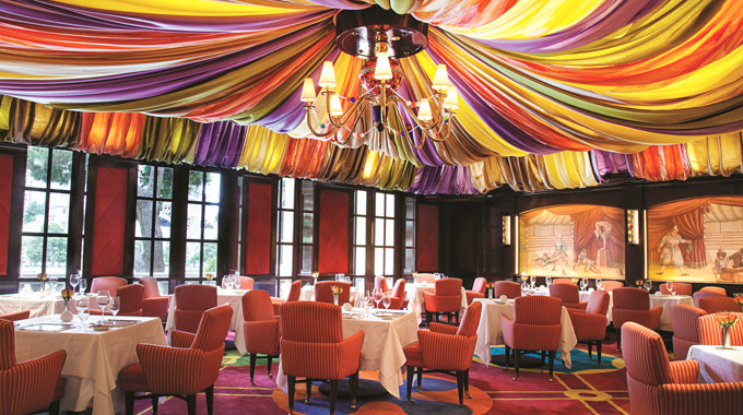Drapery hanging from the ceiling in Le Cirque dining room is reminiscent of a circus tent