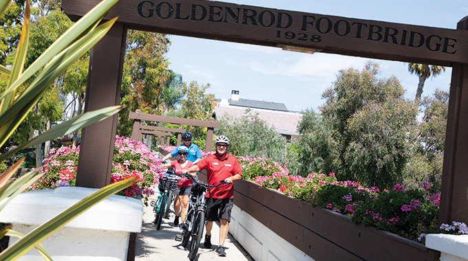 Walking e-bikes across the Goldenrod Footbridge in Corona del Mar, California. | Photo by Eric Van Eyke