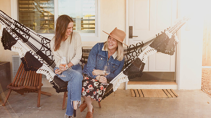 A pair of women sharing a hammock