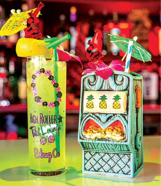 A pair of colorful drinks on the bar at High Roller Tiki Lounge