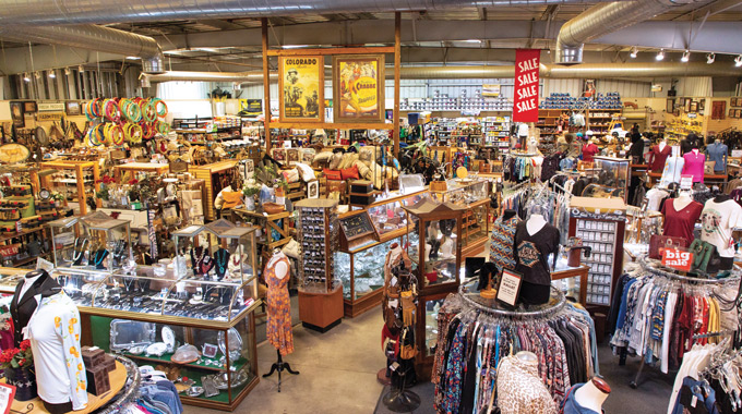 Racks of clothing and other items for sale inside Big Horse Feed and Mercantile