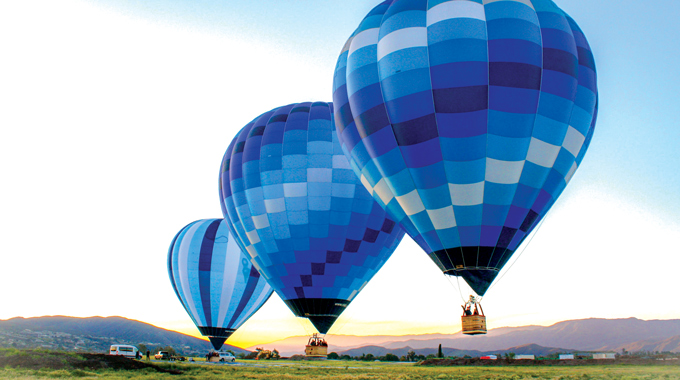 Three hot air balloons rising into the sky