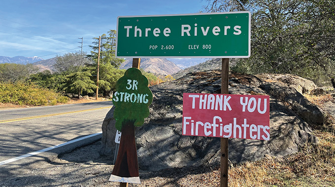 Three Rivers road sign, along with one reading "thank you firefighters"
