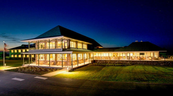 Lights glowing along the wraparound porch at Queen Wilhelmina Lodge