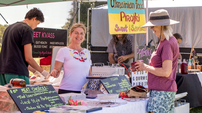 Vendor and shopper at a booth for Ukranian food