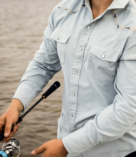 Fisherman wearing a long-sleeved collared shirt by Western Aloha.