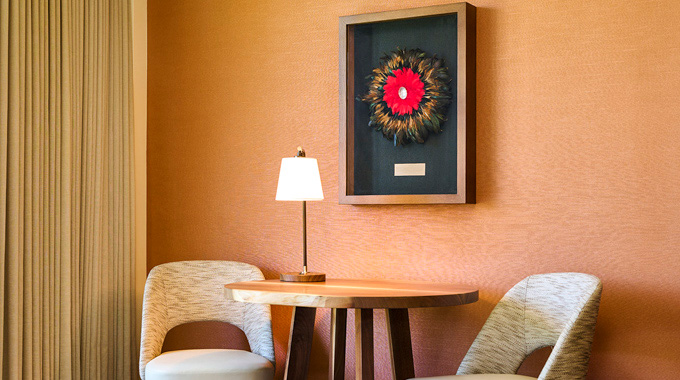 A  ‘ulī‘ulī inside a shadowbox hanging over a seating area at Ka'anapali Beach Hotel