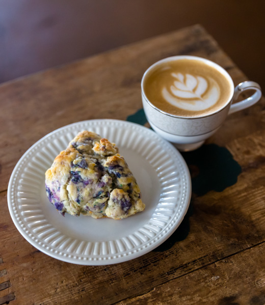 Ube scone served with a cup of coffee