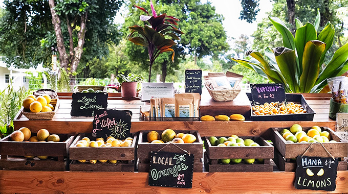 The roadside open-air market at Hāna Farms sells fresh produce along with crafts from local artisans and made-on-site spices, sauces, spreads, and baked goods. | Photo by Peg Owens/Alamy Stock Photo