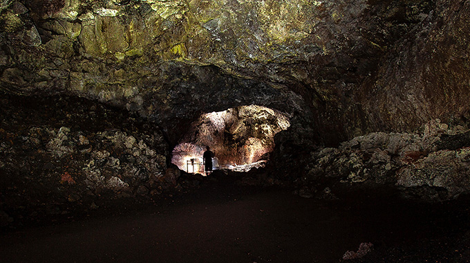 Visitors can walk a quarter-mile into the 2-mile-long Hāna Lava Tube. Flashlights are provided for safety and for viewing the stalactites, stalagmites, and other geological formations. | Photo by Paul Horsley/Alamy Stock Photo