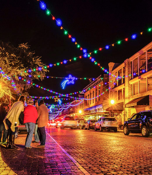Holiday lights strung overhead along Front Street in Natchitoches.