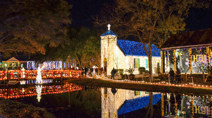 The Acadian Village glowing with holiday lights during the Noel Acadian au Village celebration.