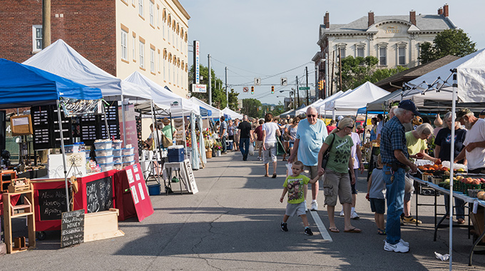 Vendors and shoppers line the street during the New Albany Farmers Market