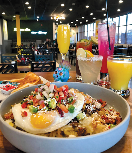 Breakfast bowl topped with a fried egg and pico de gallo