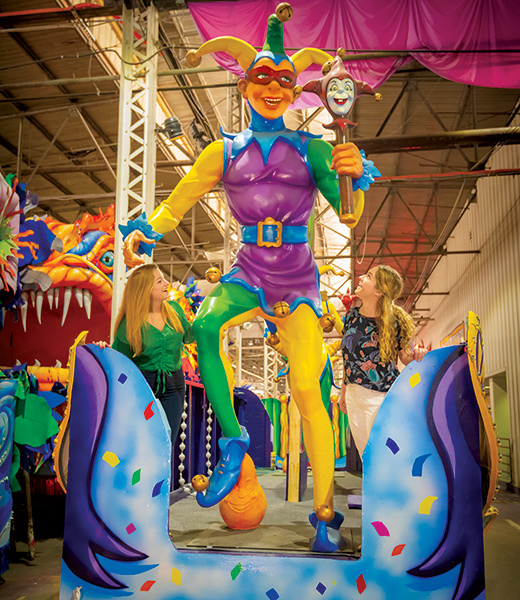 Museum visitors admiring a float at Mardi Gras World