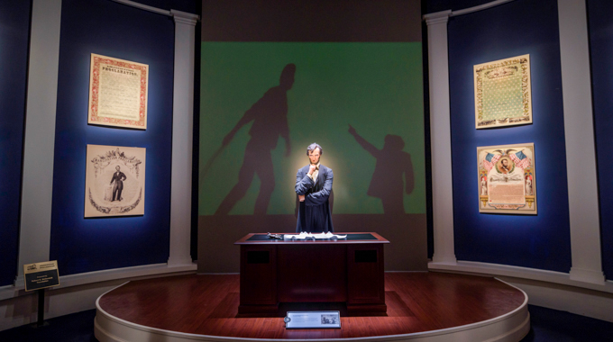 An exhibit at the Lincoln Museum showing the former president standing pensively at his desk