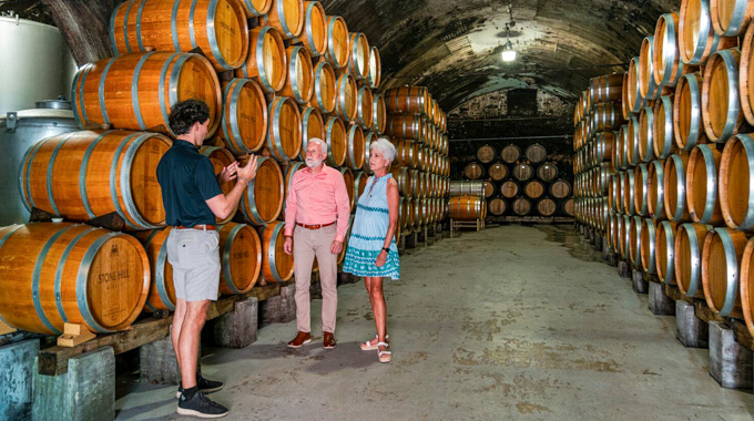 Couple touring the wine cellar at Stone Hill Winery.