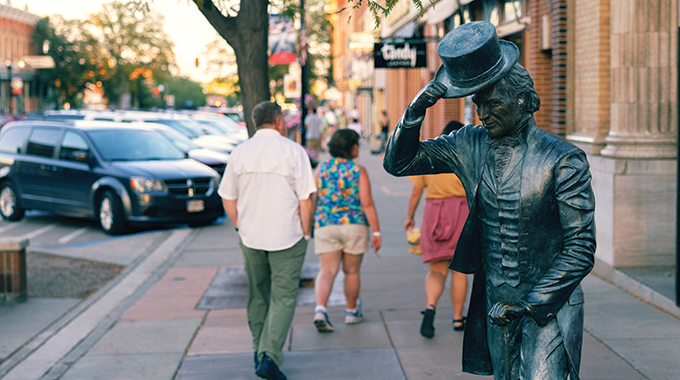 Statue of James Monroe tipping his hat to passersby.