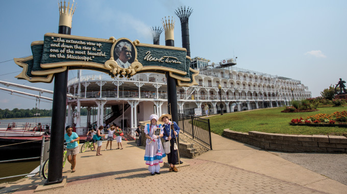 Costumed characters wait on the entrance to The American Queen
