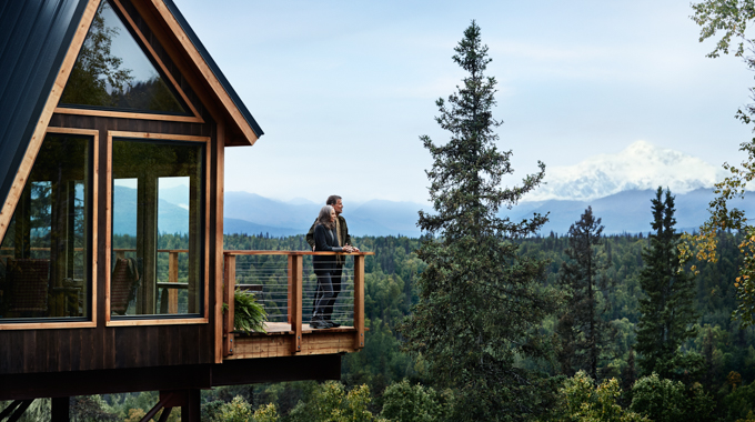 A couple on a balcony at Mt. McKinley Princess Wilderness Lodge