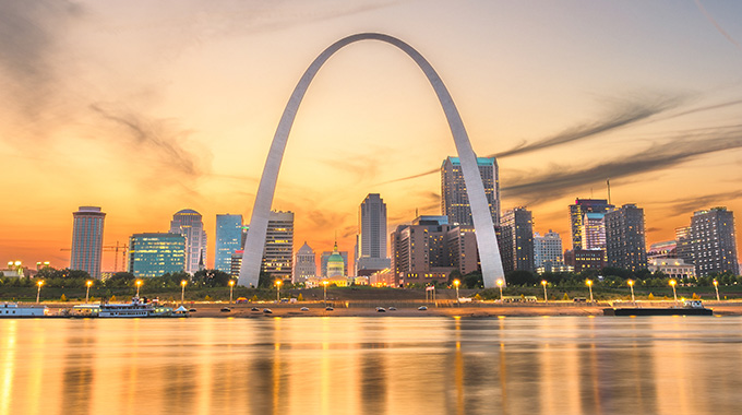 Gateway Arch appears to loom over buildings in St. Louis
