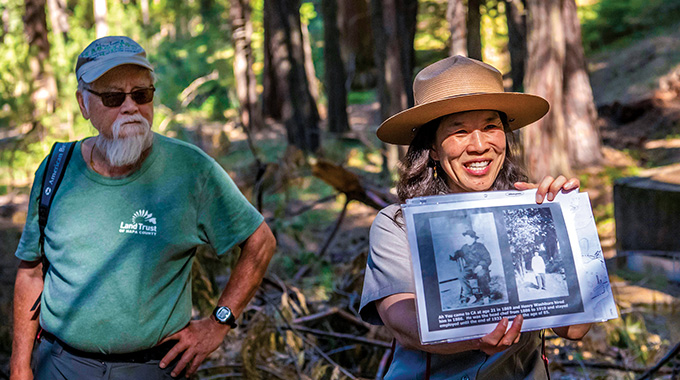 Ranger Yenyen Chan shows archival photos to the group. | Photo by Eric Paul Zamora