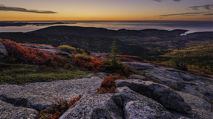 A golden panorama rewards those who venture to the mountaintop before daybreak. | Photo by Harry Lichtman